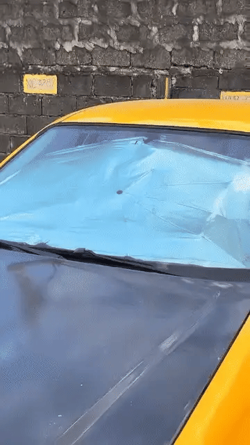 Portable Denx car umbrella by My Store shown covering a vehicle to protect from sun and rain in a compact, easy-to-use design.
